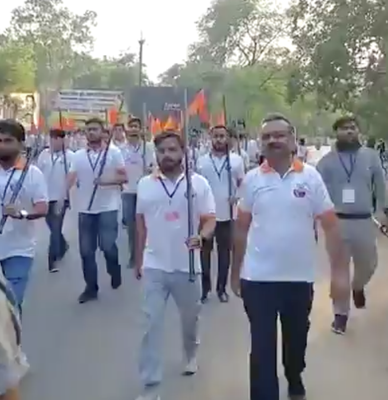 Bajrang Dal members organize road march holding canes and saffron flags in Mandla